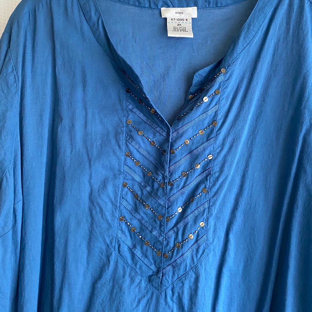 Beautiful blue with ruffled hem. Very cute on.